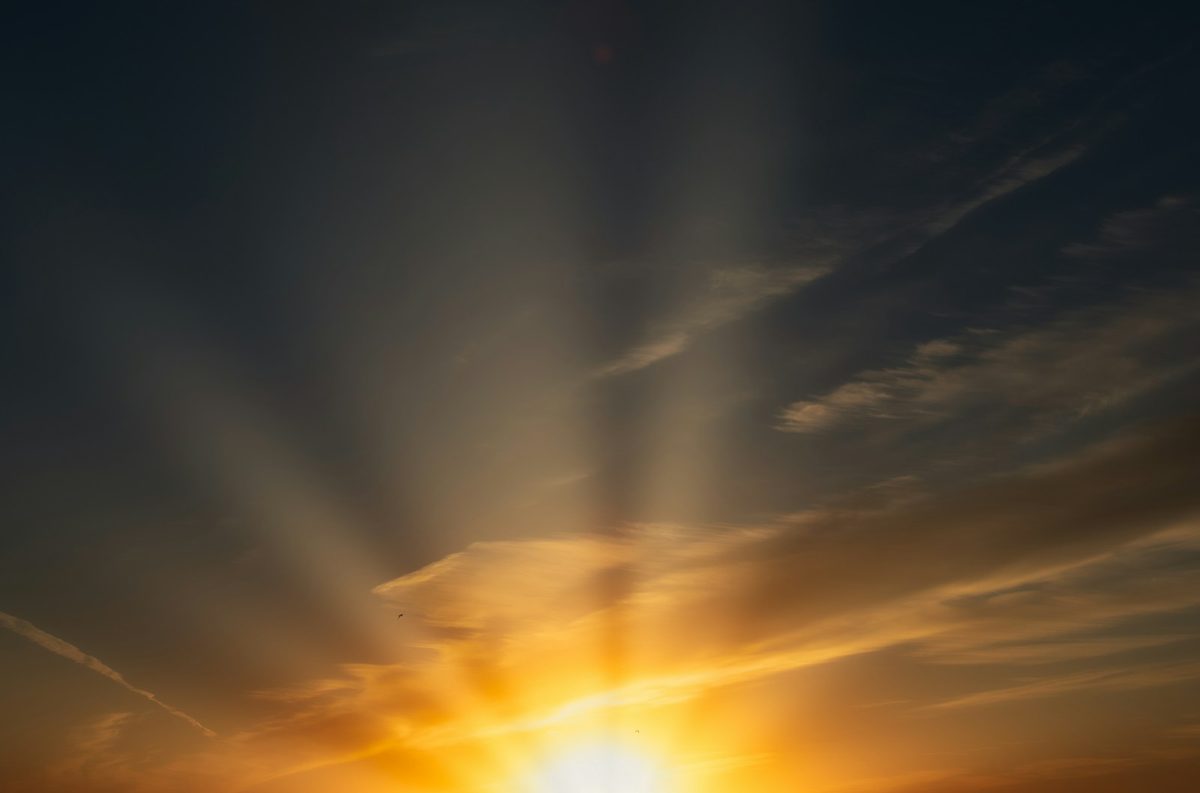 Golden sunlight over deep blue water at dawn.
